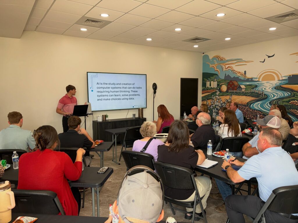 A presenter talking to a room of business professionals.