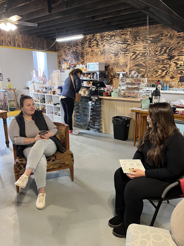 Two women talking in a coffee shop.